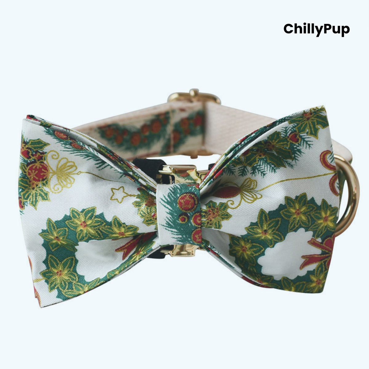 Dog collar with a festive bow tie featuring Christmas-themed patterns on a white background.