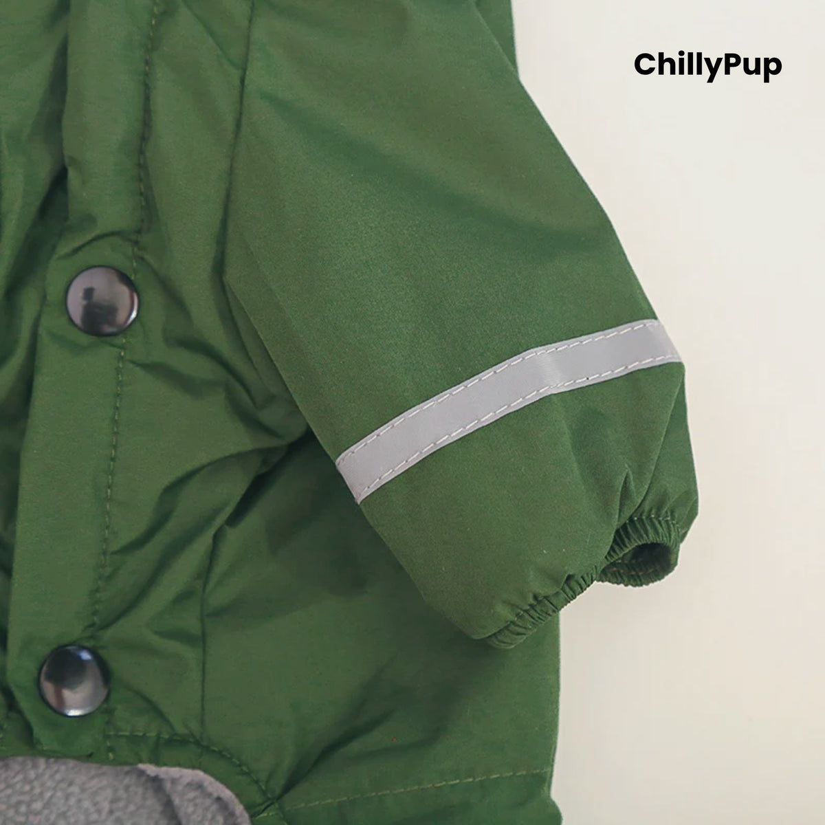 Close-up of the reflective strip and elasticated cuff on the Puddle Jumper Fleece-Lined Dog Raincoat